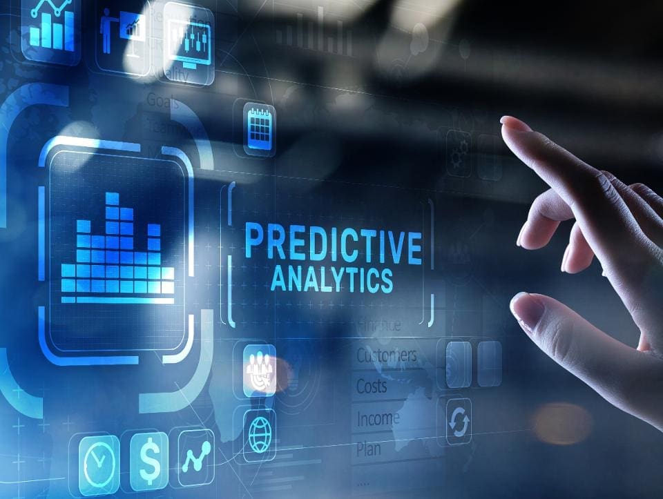 WRLD A hand points at predictive analytics on a screen showcasing technology trends.